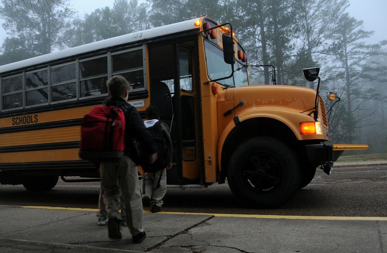 kids getting on school bus