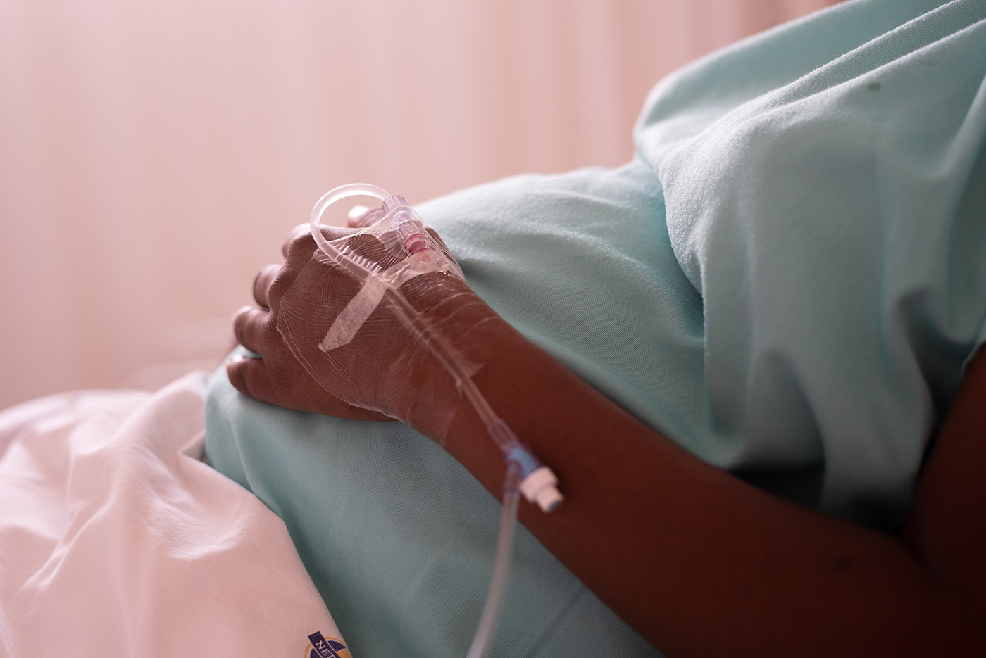 A pregnant woman in labor, lying in a hospital bed waiting for h